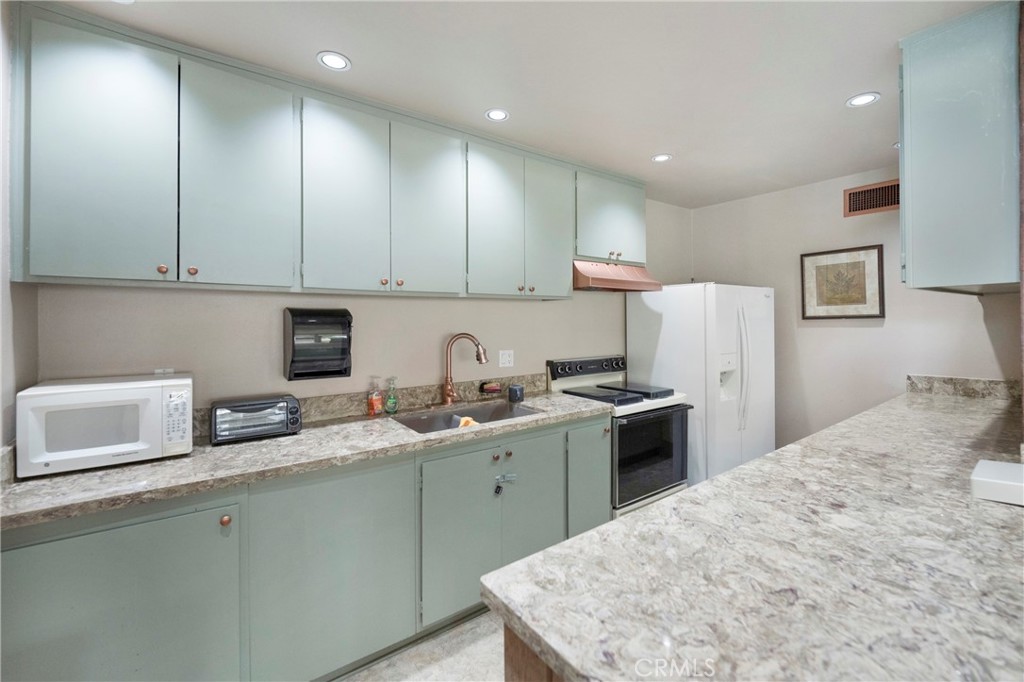 242 Mountain Court Brea, CA 92821 - Photo 47 of 54 a kitchen with a sink and a refrigerator