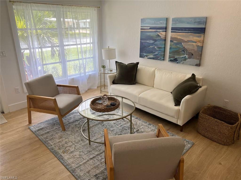 1220 Embassy Lane Naples, FL 34104 - Photo 6 of 11 a living room with furniture and a large window
