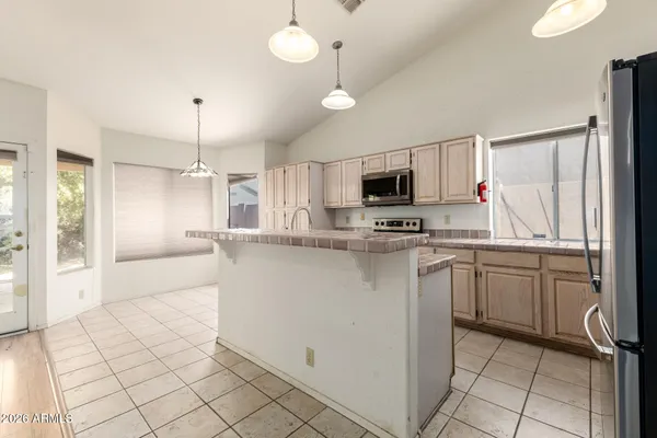 a kitchen with stainless steel appliances a refrigerator sink and microwave