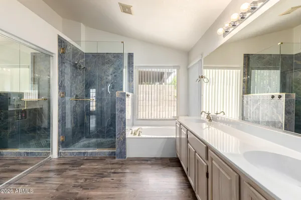 a bathroom with a tub sink and shower