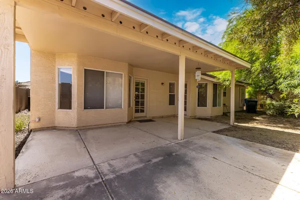 a view of a patio with table and chairs