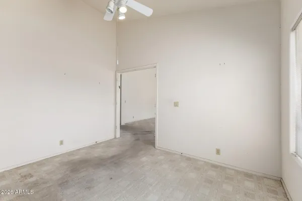 an empty room with a chandelier fan