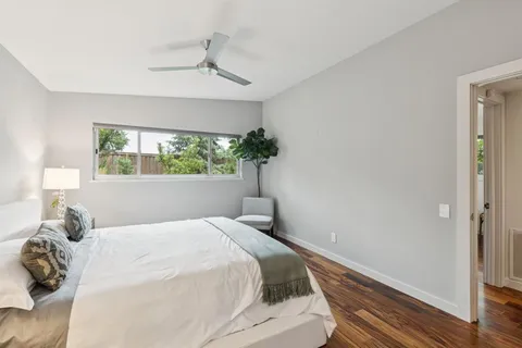 a bedroom with a bed and a window