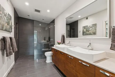a spacious bathroom with a double vanity sink toilet and a shower