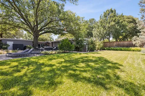 a view of swimming pool and trees in the background