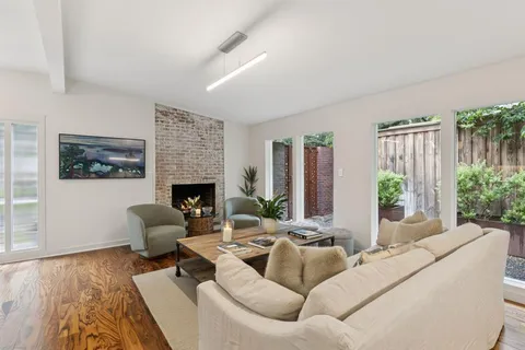a living room with furniture couches and a fireplace
