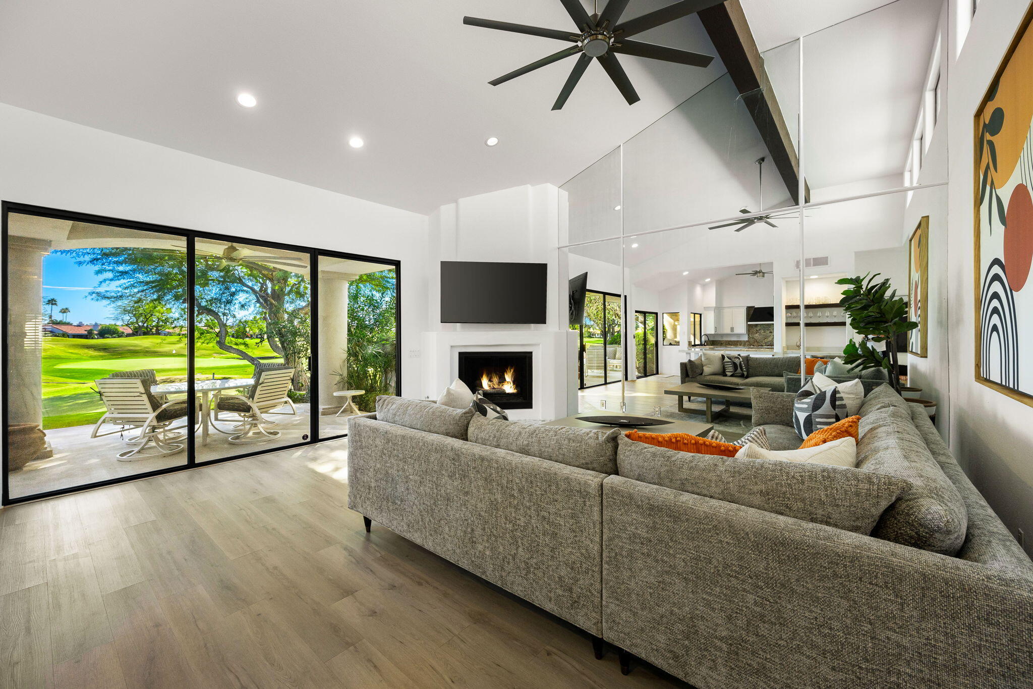 54524 Inverness Way La Quinta, CA 92253 - Photo 11 of 48 a living room with furniture floor to ceiling window and a flat screen tv