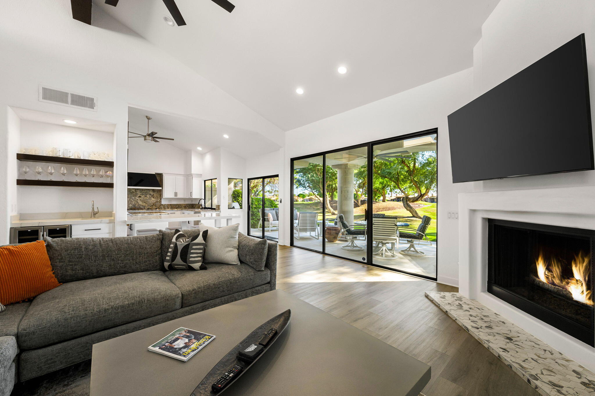 54524 Inverness Way La Quinta, CA 92253 - Photo 15 of 48 a living room with furniture a flat screen tv and a fireplace