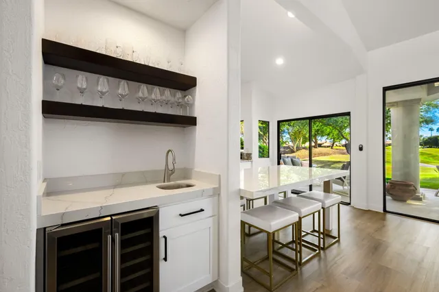 a view of a kitchen with a table and chairs in it