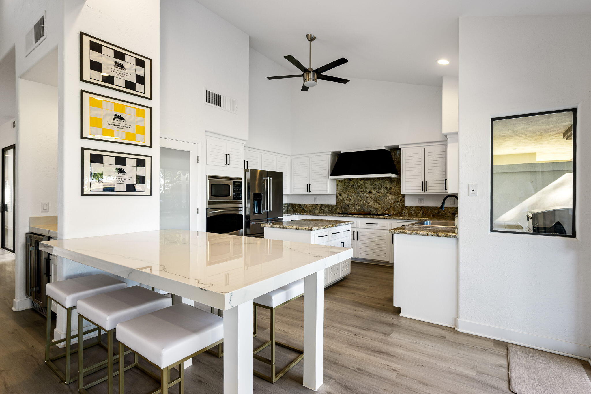 54524 Inverness Way La Quinta, CA 92253 - Photo 19 of 48 a kitchen with stainless steel appliances granite countertop a stove top oven a sink a counter space and cabinets