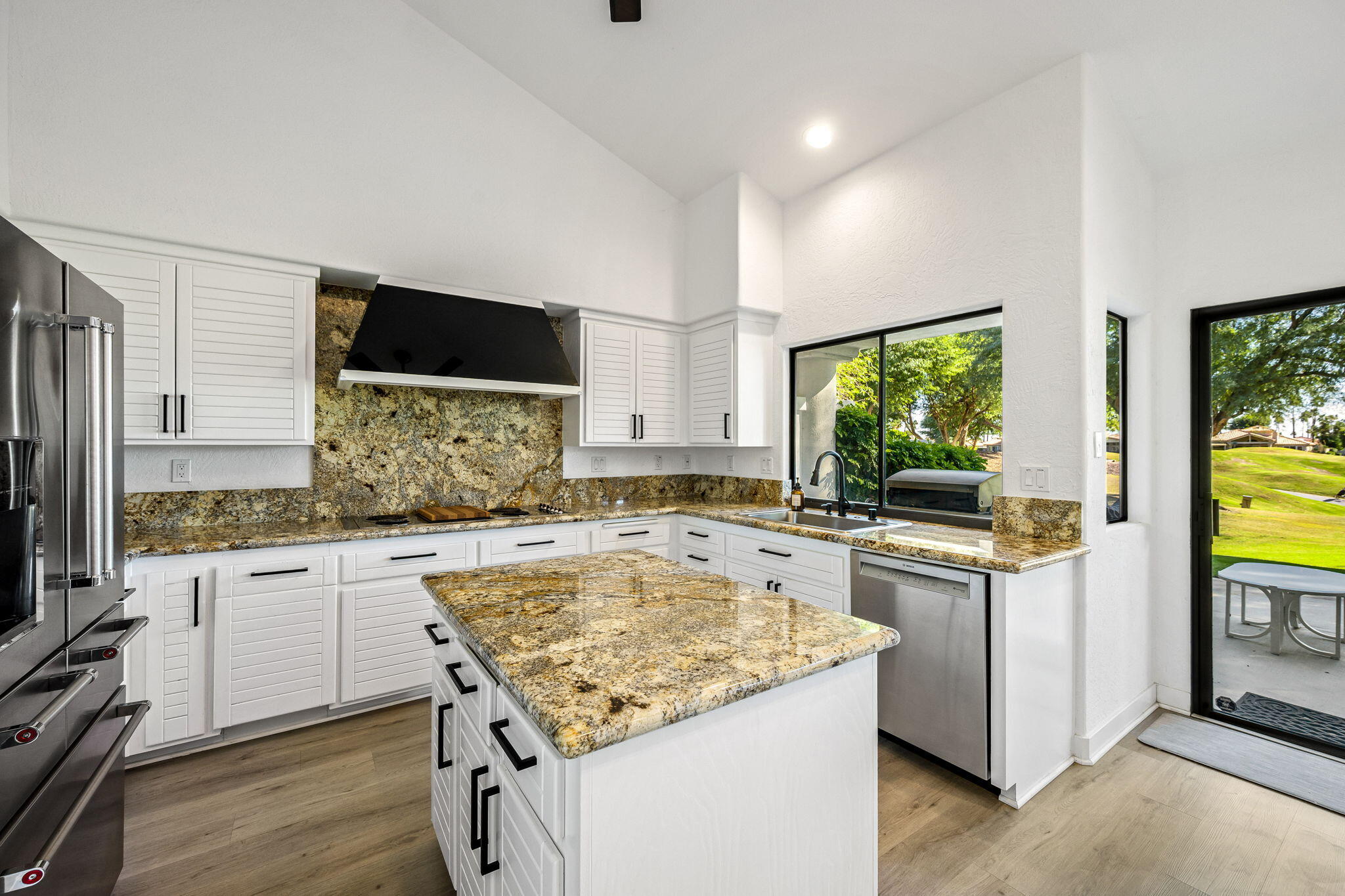 54524 Inverness Way La Quinta, CA 92253 - Photo 21 of 48 a kitchen with stainless steel appliances granite countertop a stove and a sink