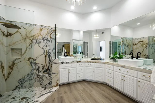 a spacious bathroom with a double vanity sink a mirror and a shower