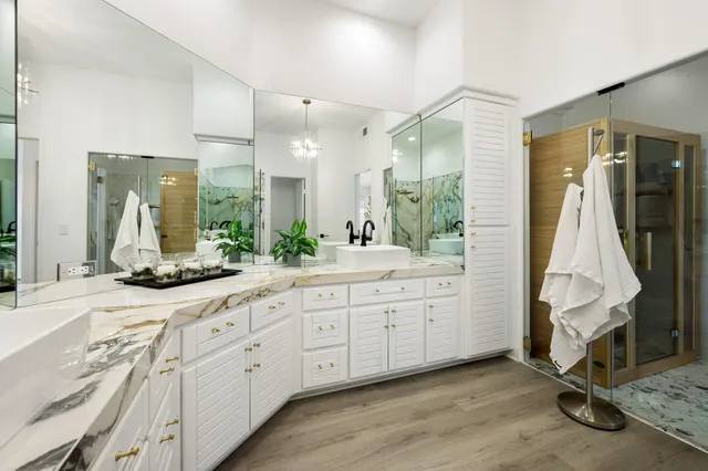 a bathroom with a double vanity sink and a mirror