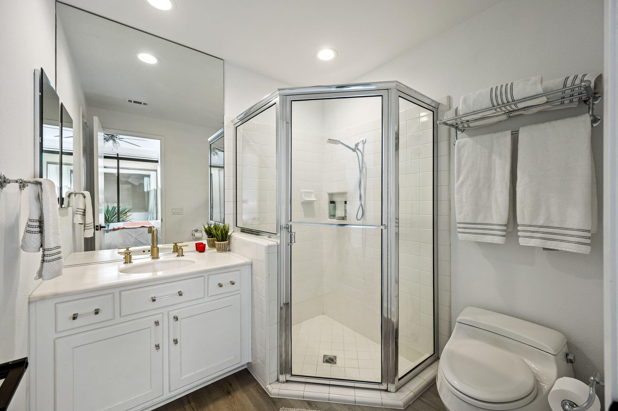 54524 Inverness Way La Quinta, CA 92253 - Photo 35 of 48 a bathroom with a double vanity sink toilet mirror and shower