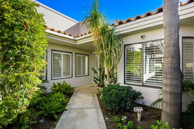 a potted plant in front of a house