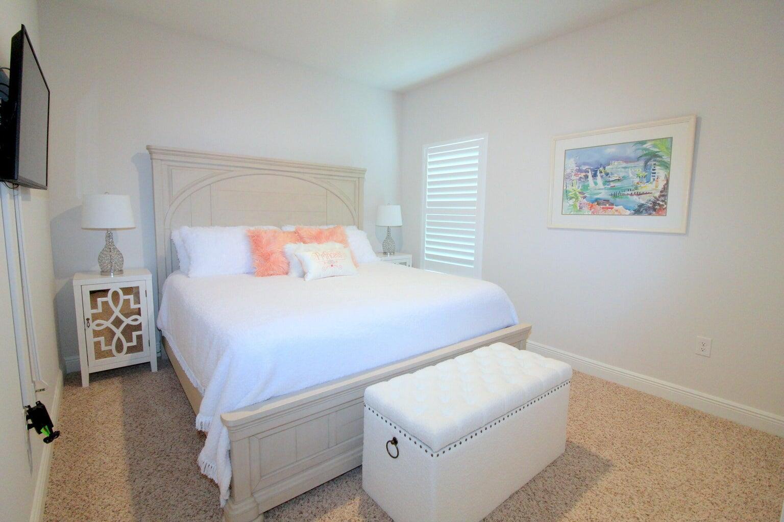 454 Lightning Bug Lane Freeport, FL 32439 - Photo 22 of 41 a bedroom with a bed and a flat screen tv