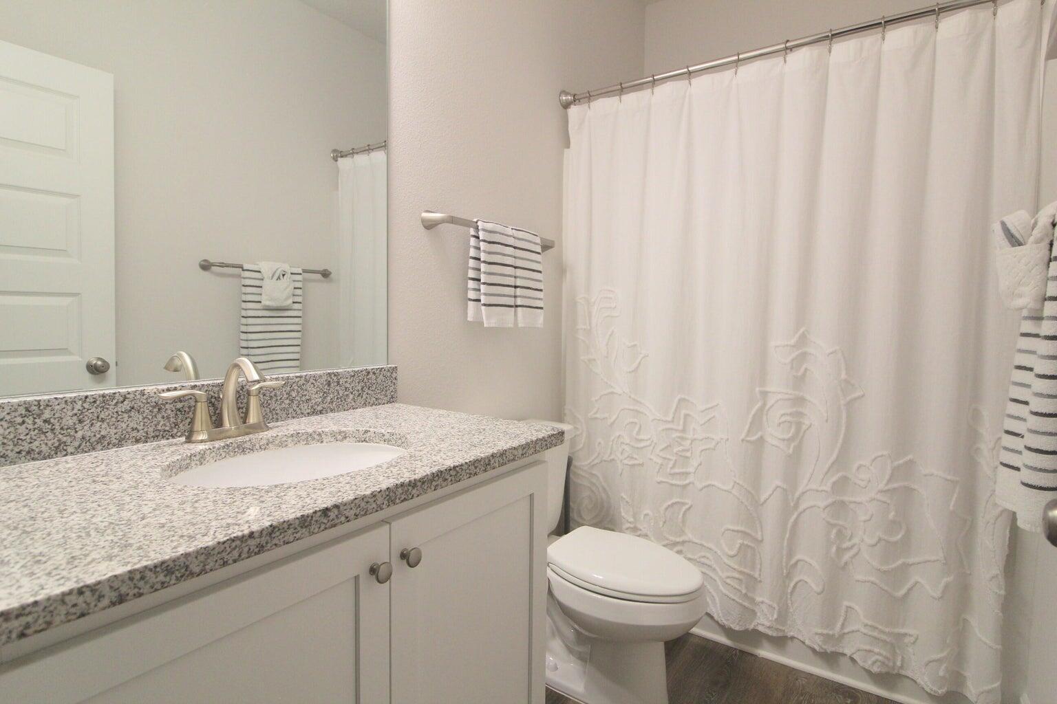 454 Lightning Bug Lane Freeport, FL 32439 - Photo 25 of 41 a bathroom with a granite countertop sink and a mirror