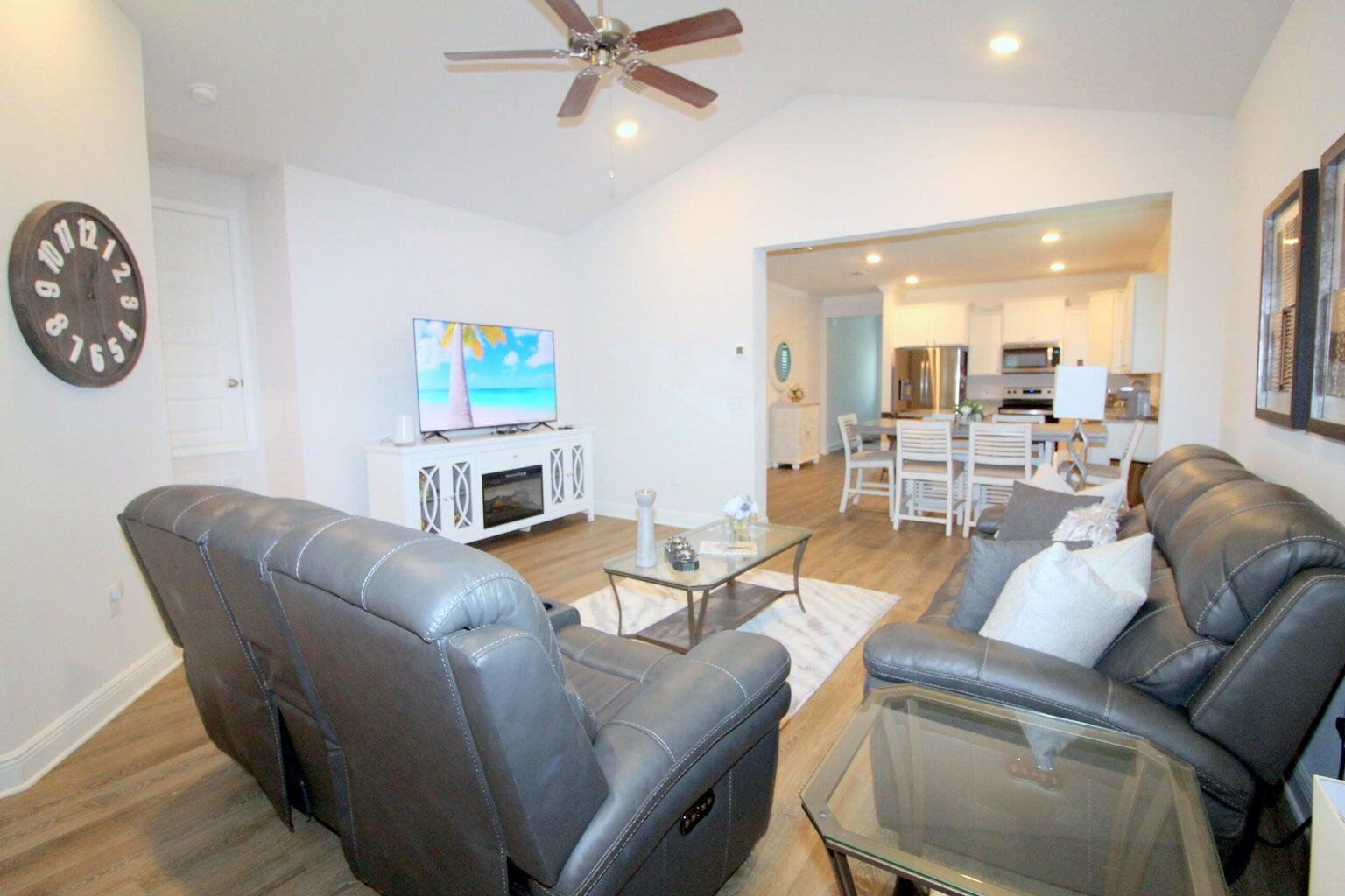 454 Lightning Bug Lane Freeport, FL 32439 - Photo 7 of 41 a living room with furniture a clock on wall and a fireplace
