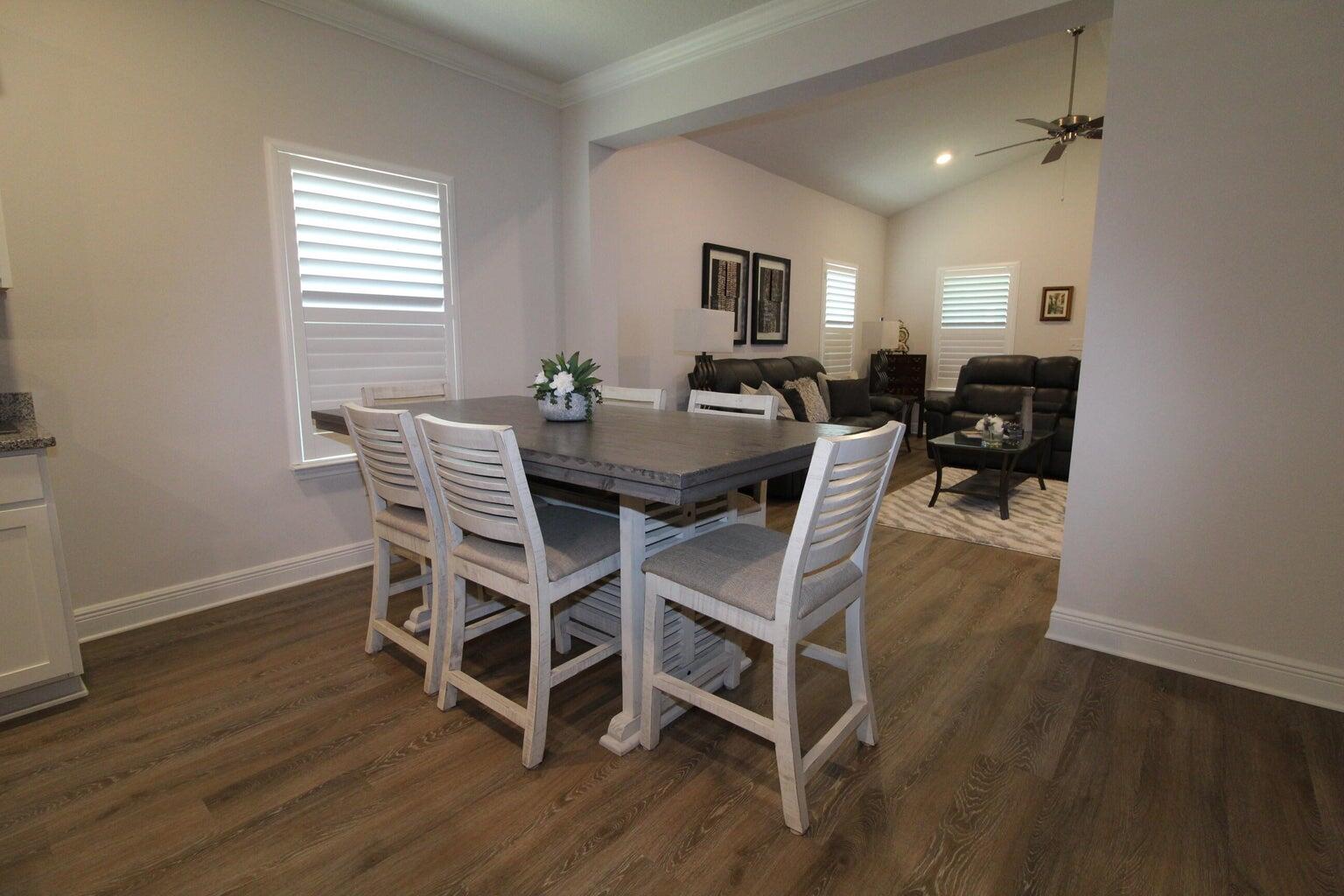 454 Lightning Bug Lane Freeport, FL 32439 - Photo 10 of 41 a view of a dining room with furniture window and wooden floor