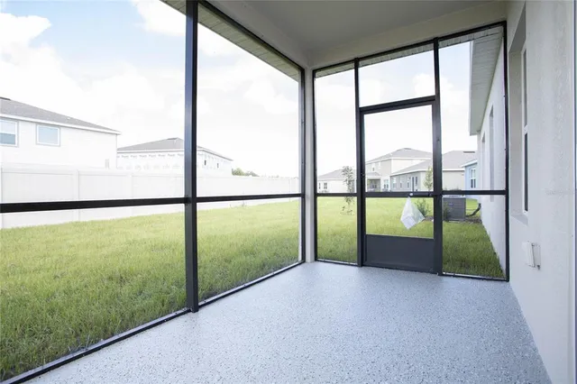 an aerial view of a house with a garden and lake view