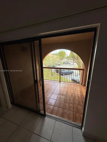 a view of an entryway door with a hallway