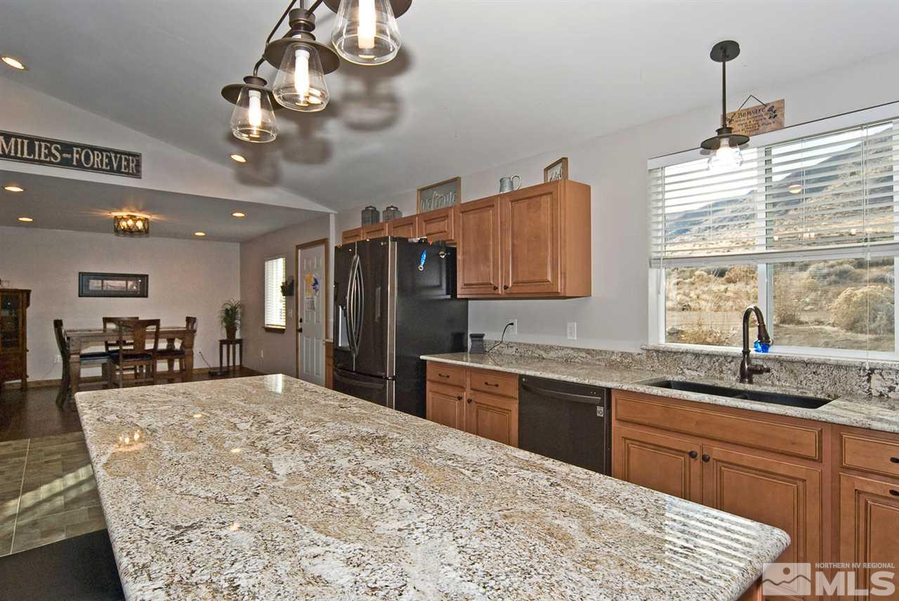 25 Prairie Way Reno, NV 89506 - Photo 5 of 16 a kitchen with stainless steel appliances kitchen island granite countertop a sink stove and refrigerator