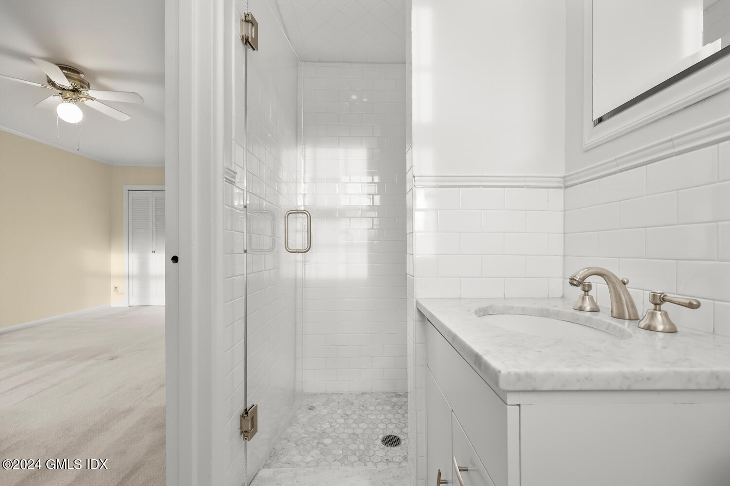 160 Putnam Park Greenwich, CT 06830 - Photo 16 of 27 a bathroom with a shower sink and mirror