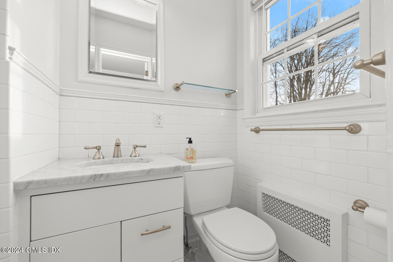 160 Putnam Park Greenwich, CT 06830 - Photo 17 of 27 a bathroom with a toilet a sink and mirror