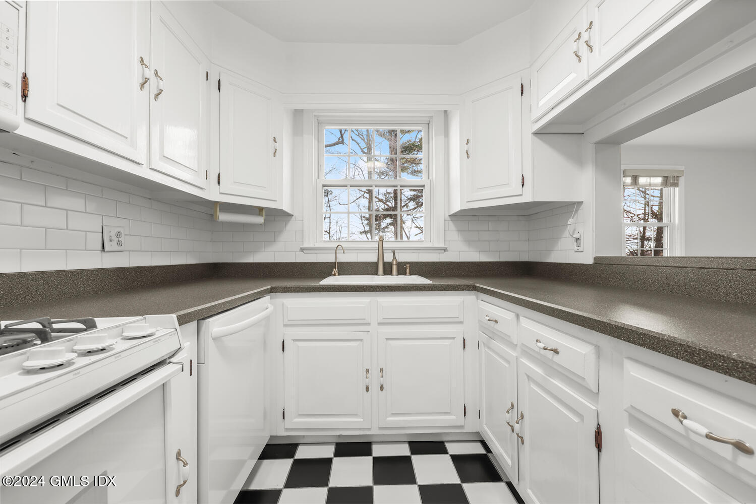 160 Putnam Park Greenwich, CT 06830 - Photo 8 of 27 a kitchen with granite countertop white cabinets and white appliances