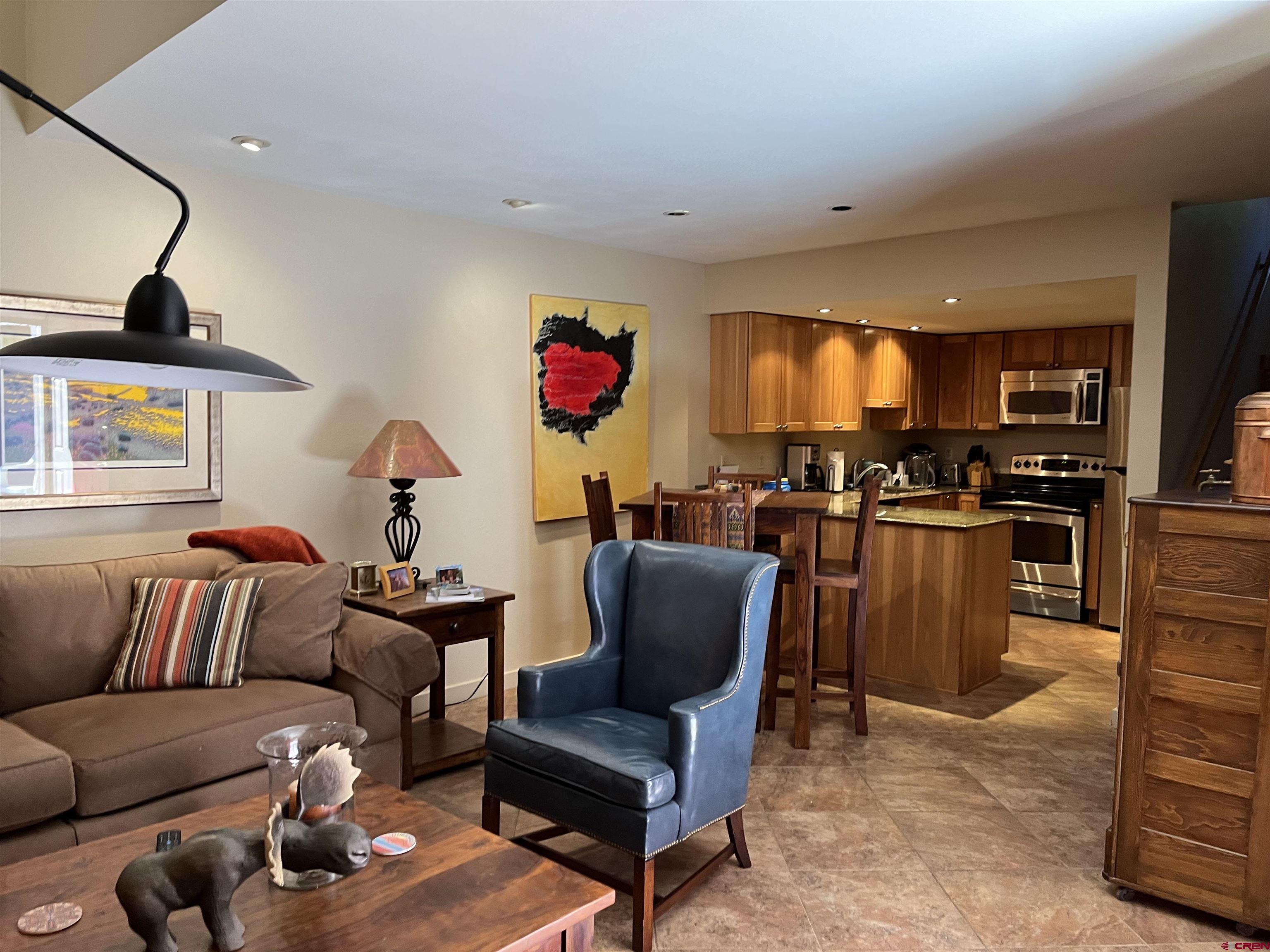 6 Ferringway Circle, Unit 22 Durango, CO 81301 - Photo 4 of 15 a living room with furniture a kitchen view and a fireplace