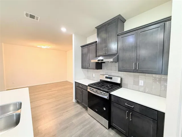 a view of a kitchen with microwave and a ceiling fan