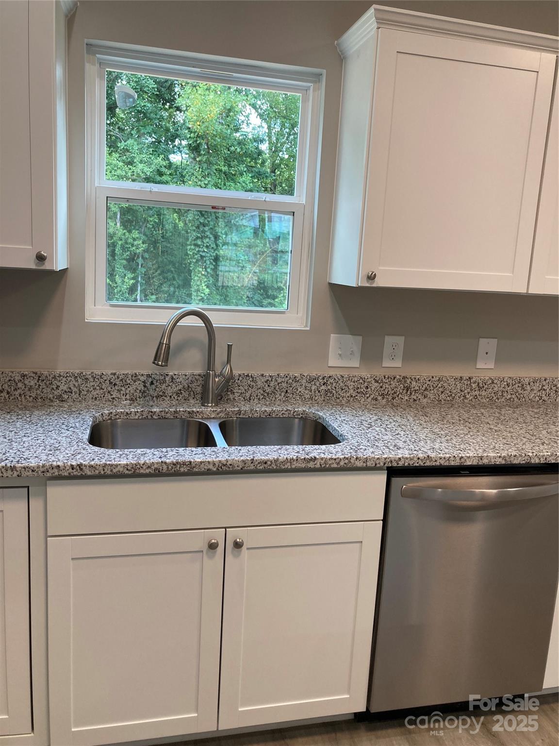 318 Davis Park Road Gastonia, NC 28052 - Photo 12 of 24 a kitchen with granite countertop white cabinets and window