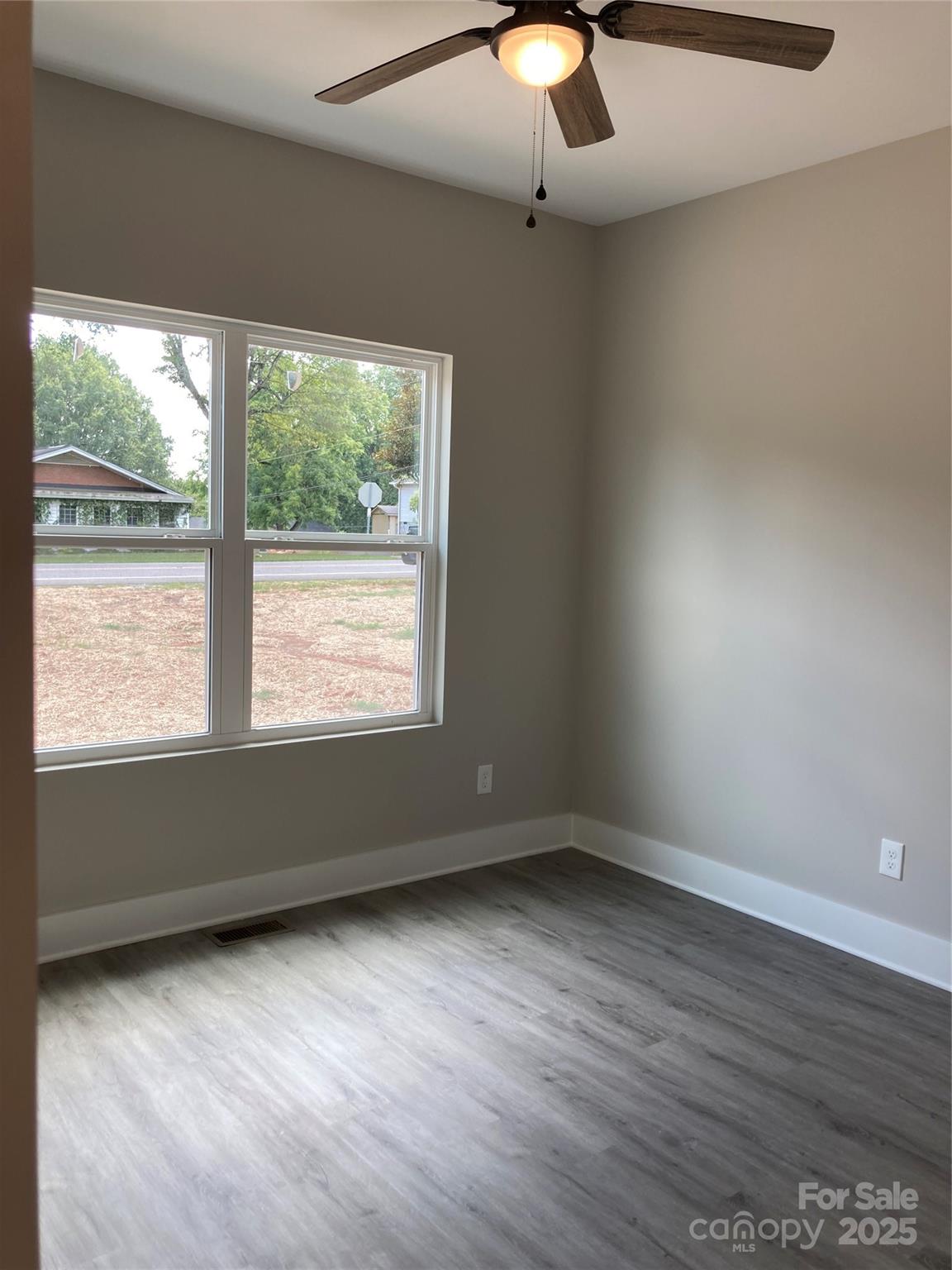 318 Davis Park Road Gastonia, NC 28052 - Photo 20 of 24 an empty room with wooden floor and windows
