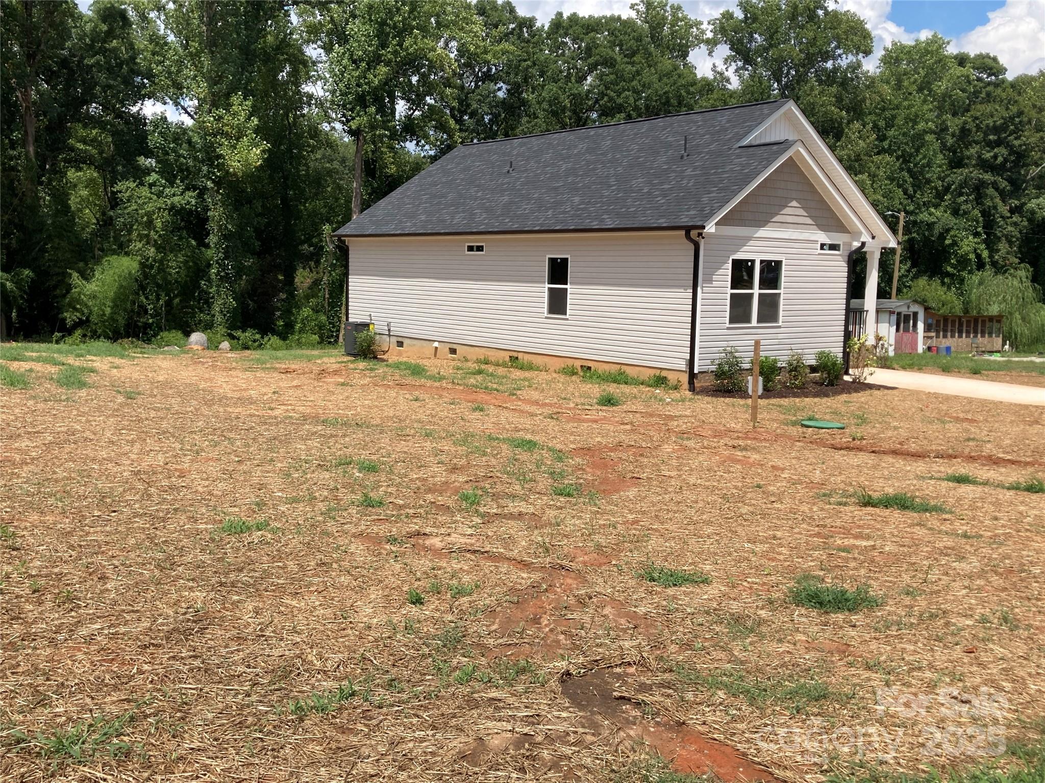 318 Davis Park Road Gastonia, NC 28052 - Photo 3 of 24 a front view of a house with a garden