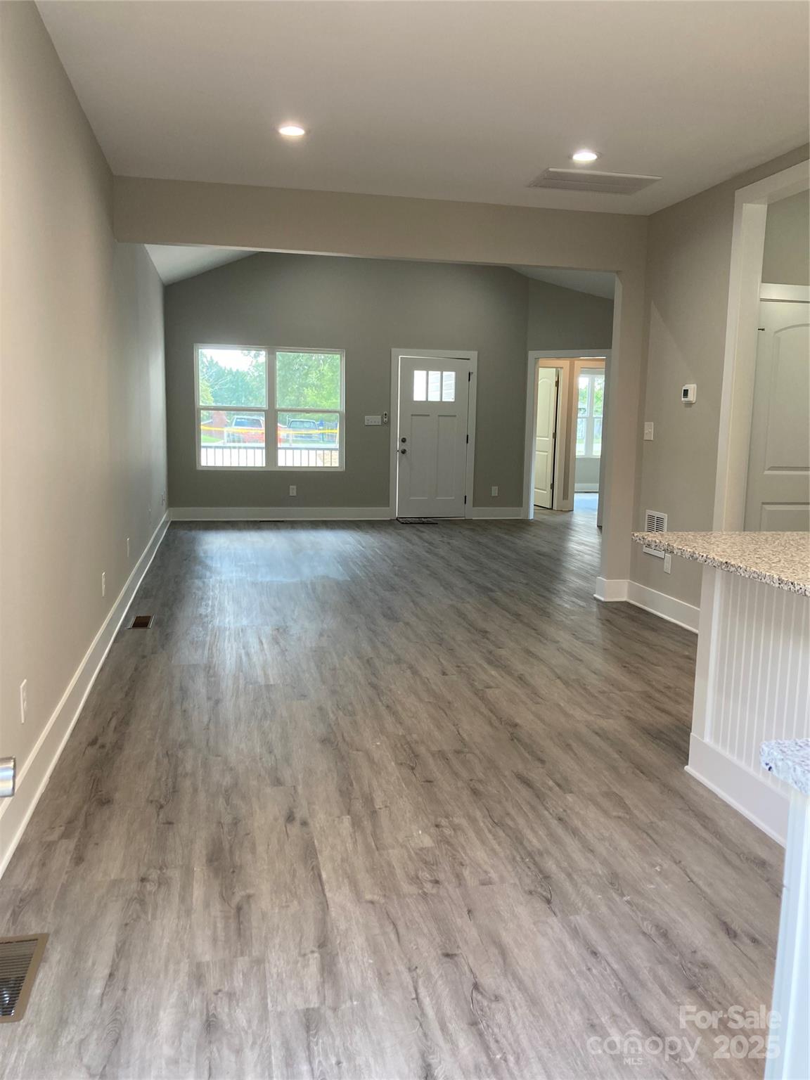 318 Davis Park Road Gastonia, NC 28052 - Photo 8 of 24 an empty room with wooden floor and windows