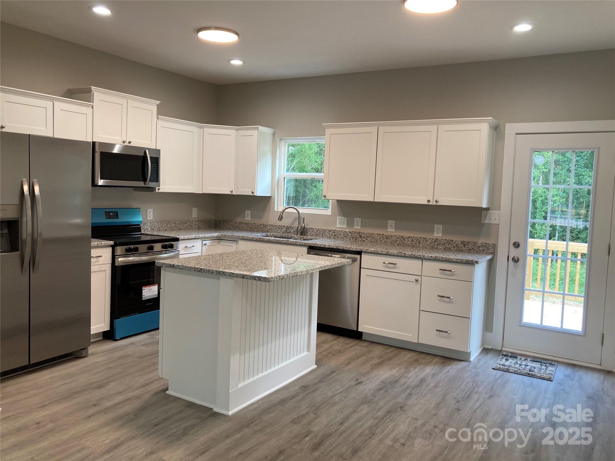 318 Davis Park Road Gastonia, NC 28052 - Photo 9 of 24 a kitchen with granite countertop white cabinets and stainless steel appliances