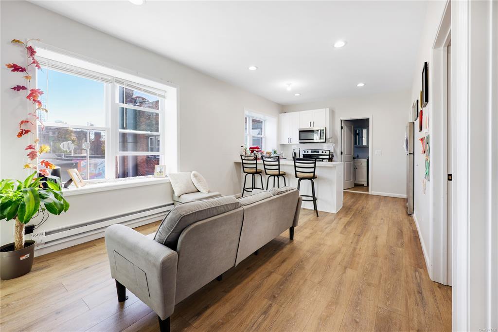 5-13 Academy Street Poughkeepsie, NY 12601 - Photo 2 of 11 Living room with a baseboard radiator and light wood-type flooring