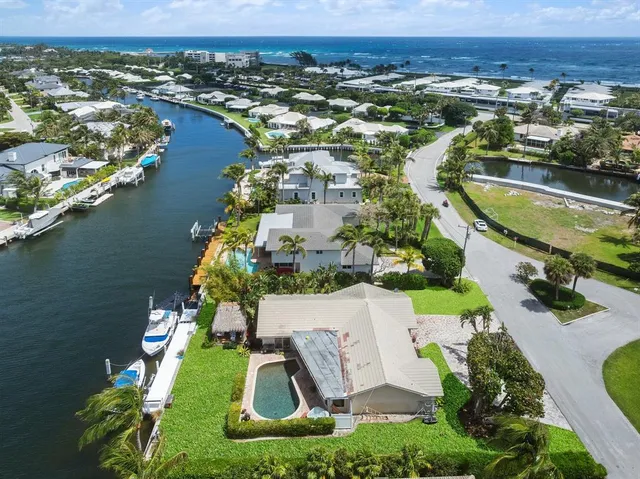 an aerial view of residential houses with outdoor space and swimming pool