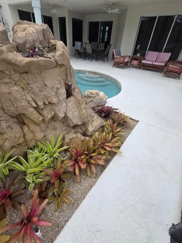 a bedroom with a bed and a chandelier fan