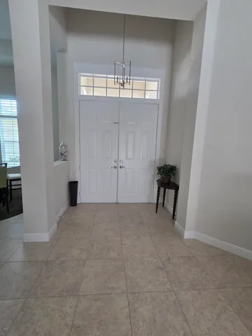 a view of hallway with sink and mirror