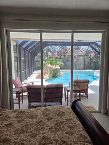 a living room with furniture and large window