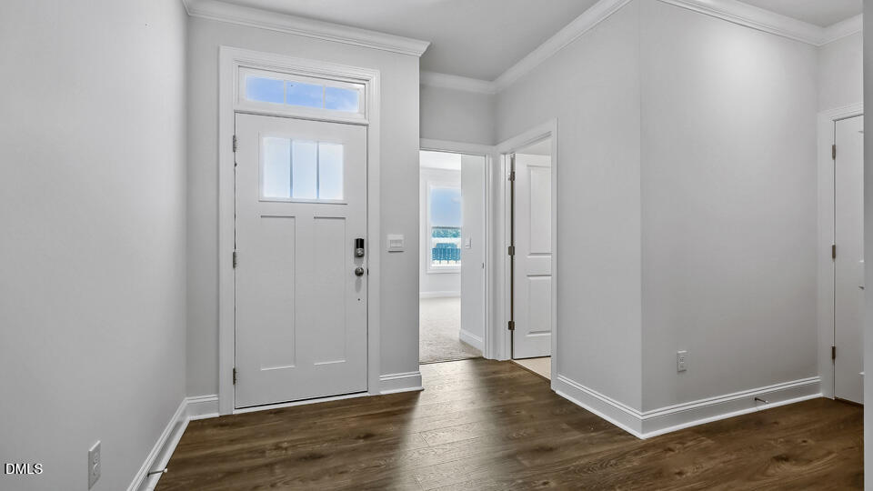 7589 Percussion Drive Apex, NC 27539 - Photo 2 of 33 an empty room with wooden floor and closet