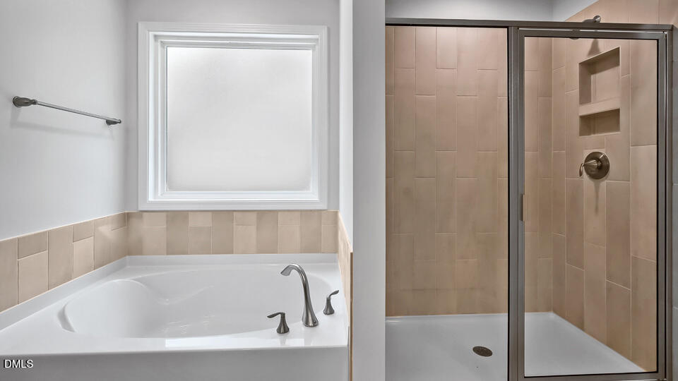 7589 Percussion Drive Apex, NC 27539 - Photo 28 of 33 a white bath tub sitting next to a shower