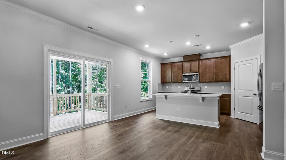7589 Percussion Drive Apex, NC 27539 - Photo 8 of 33 a view of a kitchen with microwave and stove
