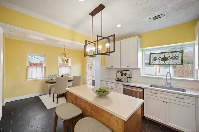 a kitchen with a table chairs stove and wooden floor
