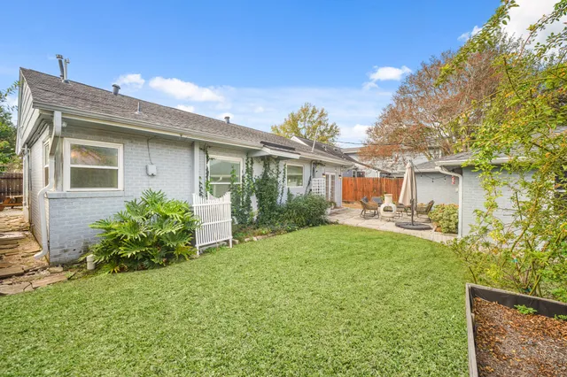 a front view of a house with a garden and sitting area