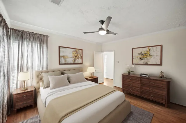 a bedroom with a bed dresser and window