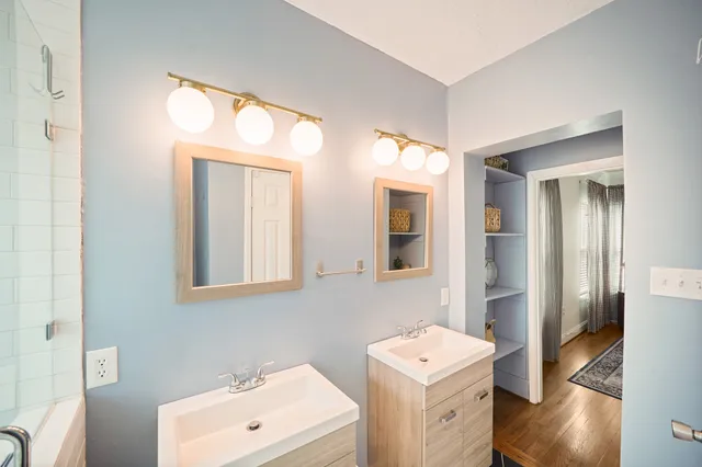 a bathroom with a sink a toilet and a mirror