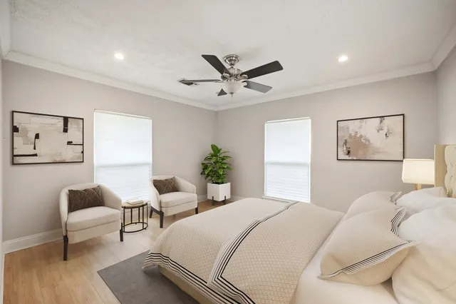 a bedroom with furniture and a large window