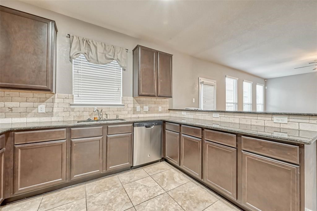 2561 Magnolia Fair Way Spring, TX 77386 - Photo 12 of 35 a kitchen with granite countertop cabinets sink and window